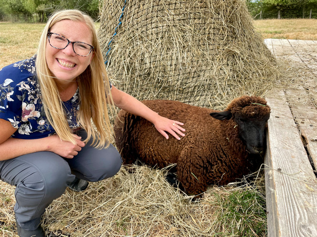 MorningStar Farm - Alexis petting a sheep